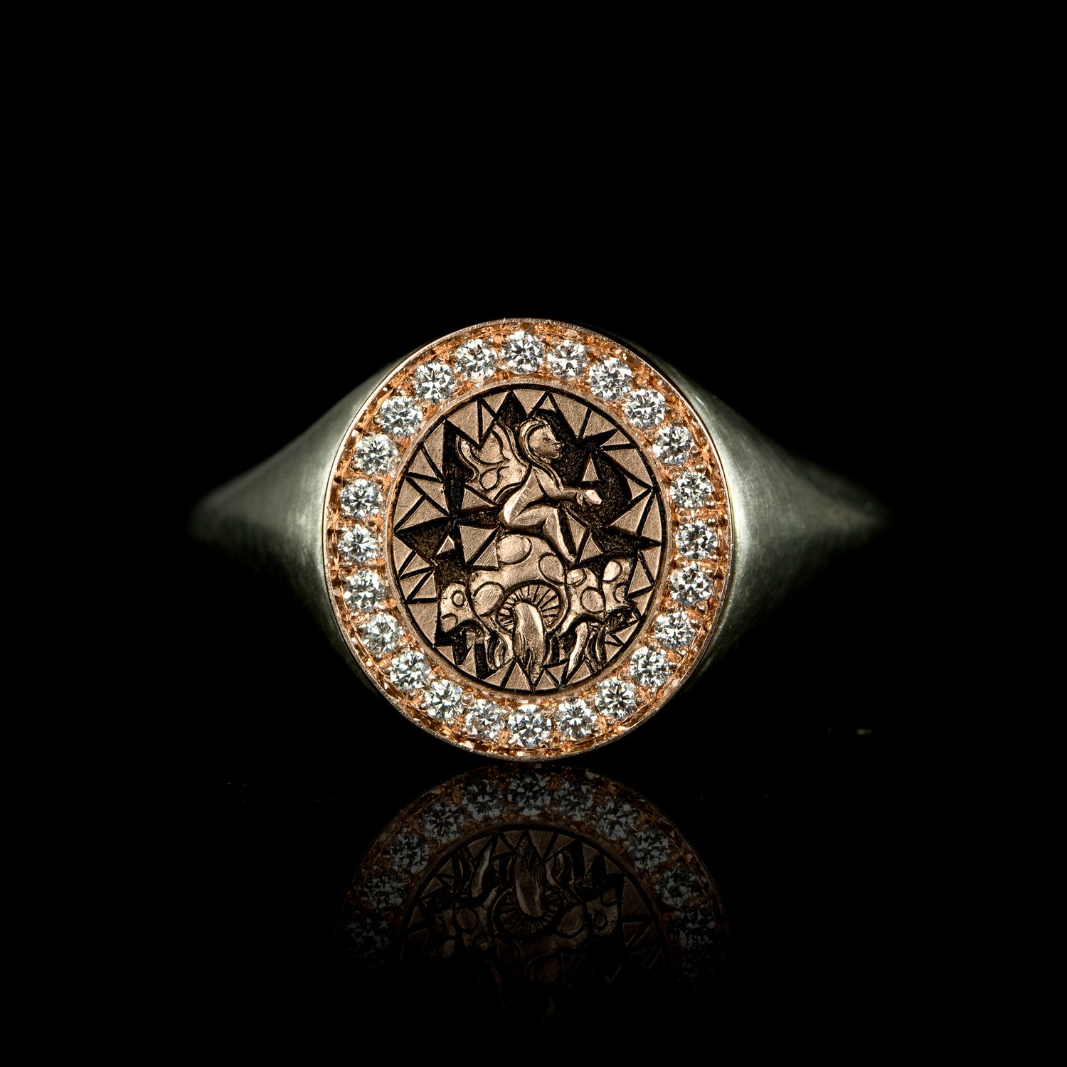 Hand engraved fantasy style signet ring in 9 carat rose gold and silver with diamonds. Features a fairy sitting on a mushroom patch.