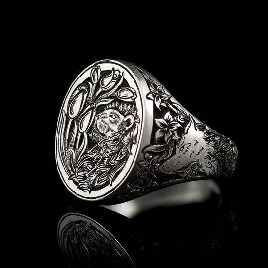 Hand engraved jewellery signet ring with lion and tulips on the top. Wolf and Lillies adorn one side of the ring