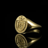 18ct yellow gold signet ring with intaglio hand engraved family crest featuring a swan, crown, shield, lion and banner with text. Deeply carved for making a seal