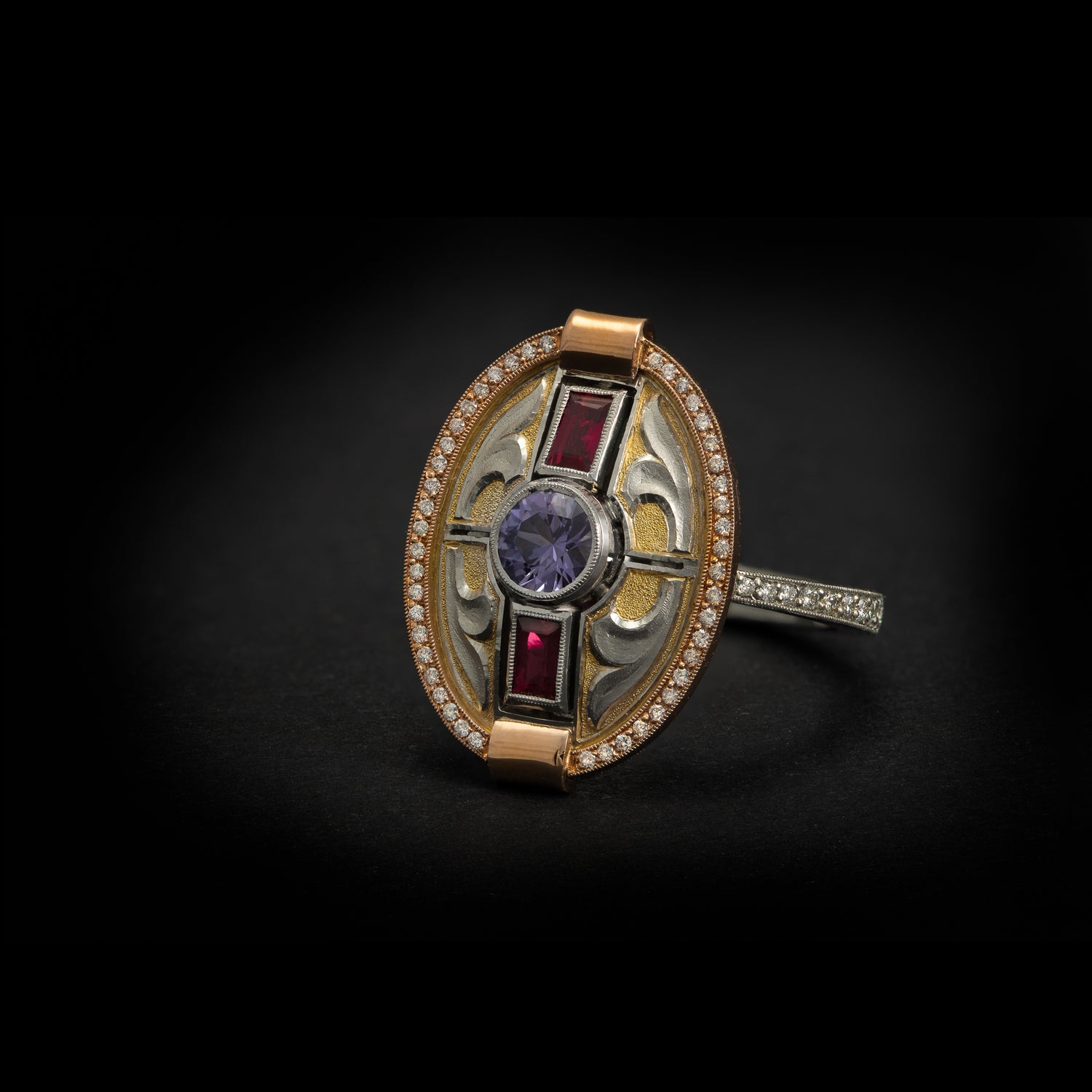 High jewellery, hand made dress ring featuring purple sapphire, rubies and diamonds. Made in platinum, 18 carat rose gold and fine gold. On black background 